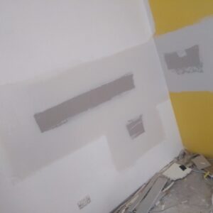 Gyprock partitioning with two walls one yellow and one white
