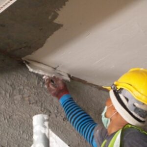 man using putty and high quality plastering material for ceiling